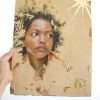 Sunborn II painting being held up with a hand