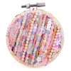 Until I Burnt Out, small circular mixed media textile artwork by Samira Stephens with heavily layered beadwork.
